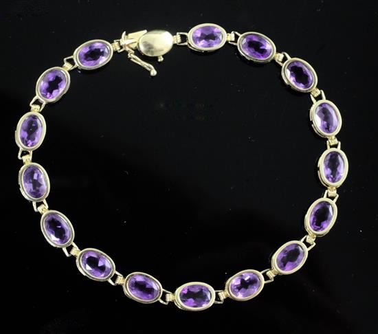 A modern 14ct gold and amethyst line bracelet, 18cm.